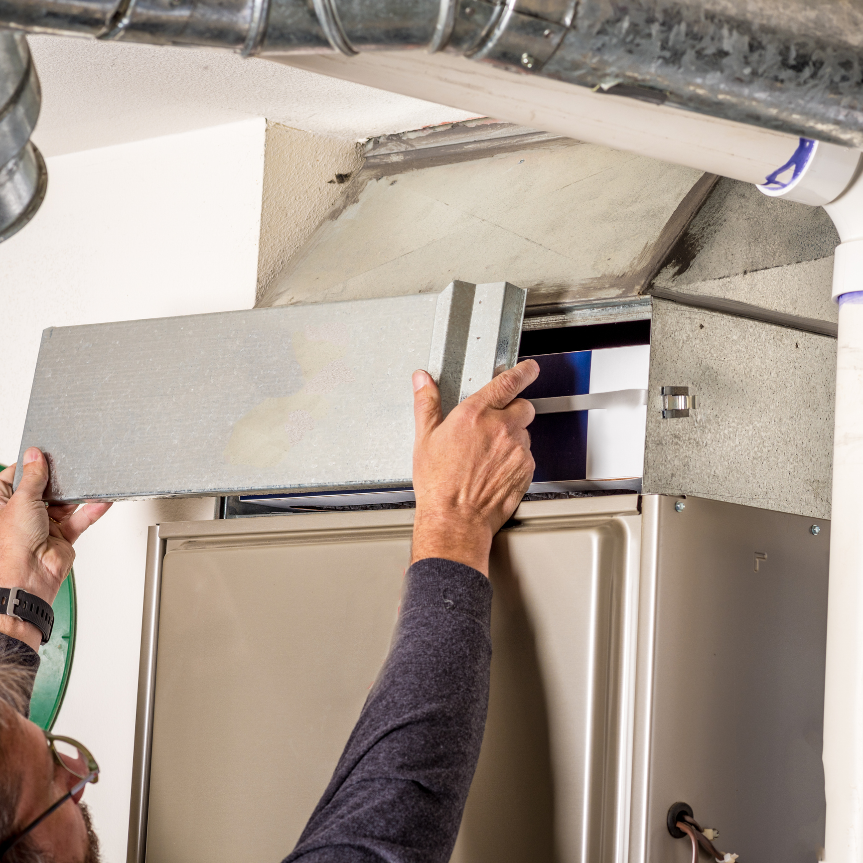 Removing furnace access panel during inspection